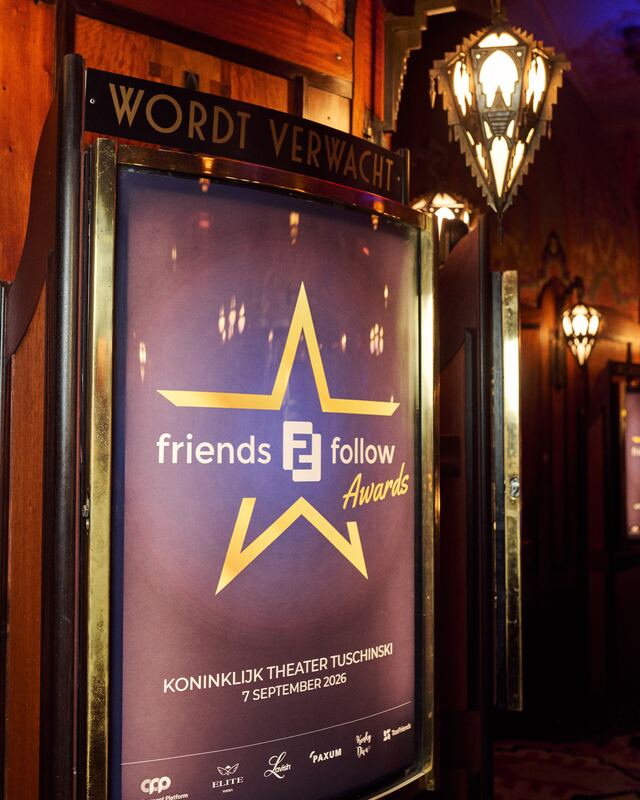 The event poster of the F2F Creator Awards 2026 in the brass display case at the entrance of Theater Tuschinski, under a sign that says Wordt verwacht