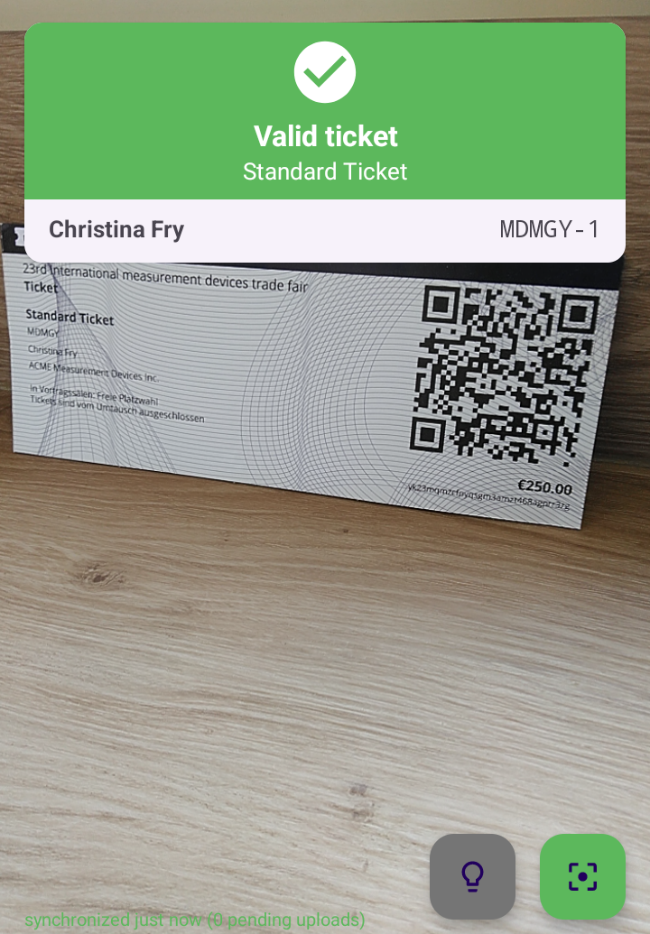 Scanner screen after a scan: green bar with Valid ticket, Standard Ticket, the guest name and the order code, with the paper ticket below